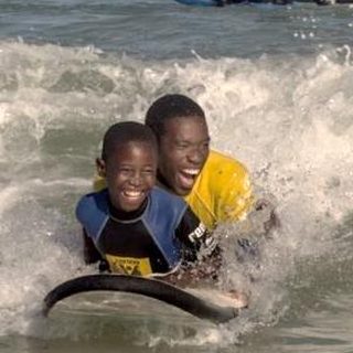 Kids surfing and giving back